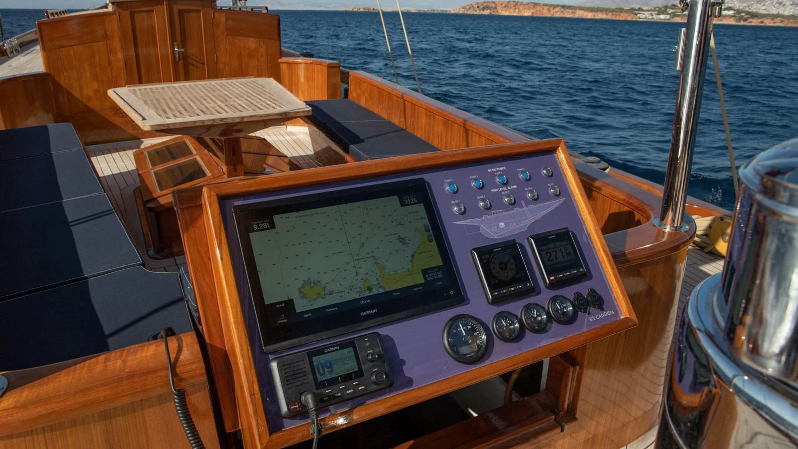 The yacht's helm features a sophisticated navigation system with a wooden finish, offering a blend of technology and classic design. aboard CANDIDA Yacht for Sale