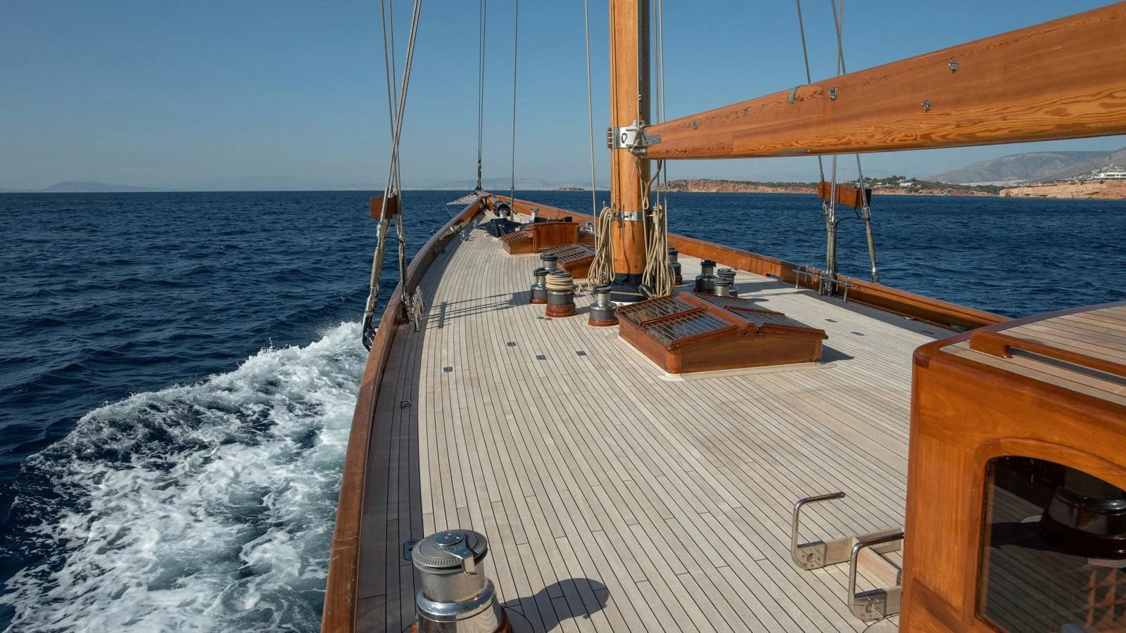 The yacht's deck showcases elegant woodwork and a spacious layout, perfect for enjoying the open sea. aboard CANDIDA Yacht for Sale