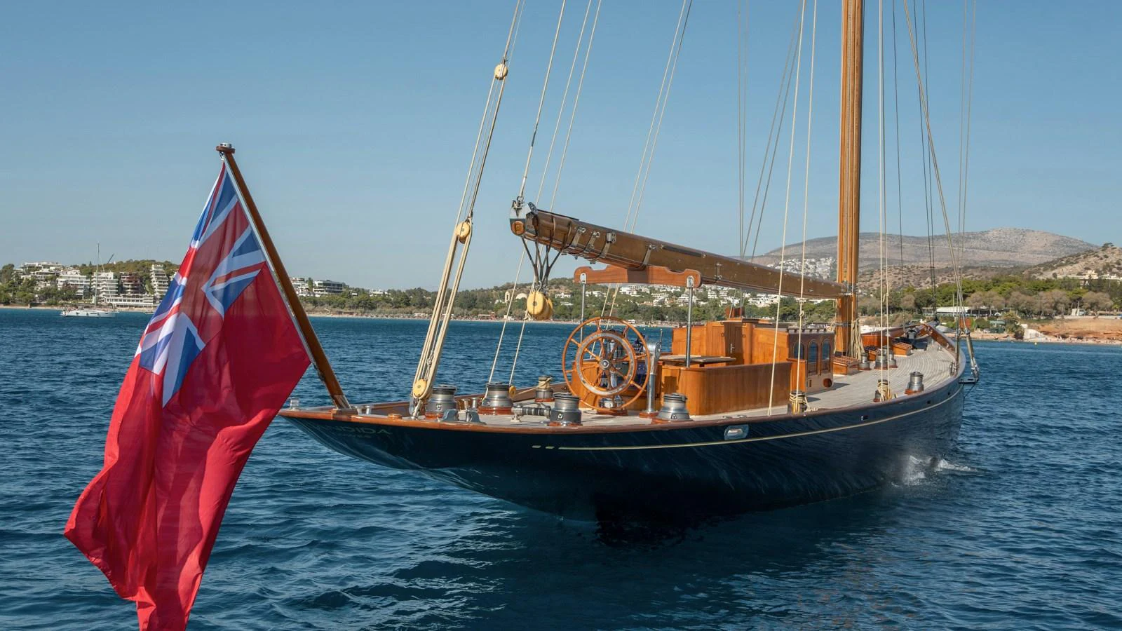 A classic sailing yacht glides gracefully on the water, showcasing its elegant wooden deck and traditional design. aboard CANDIDA Yacht for Sale