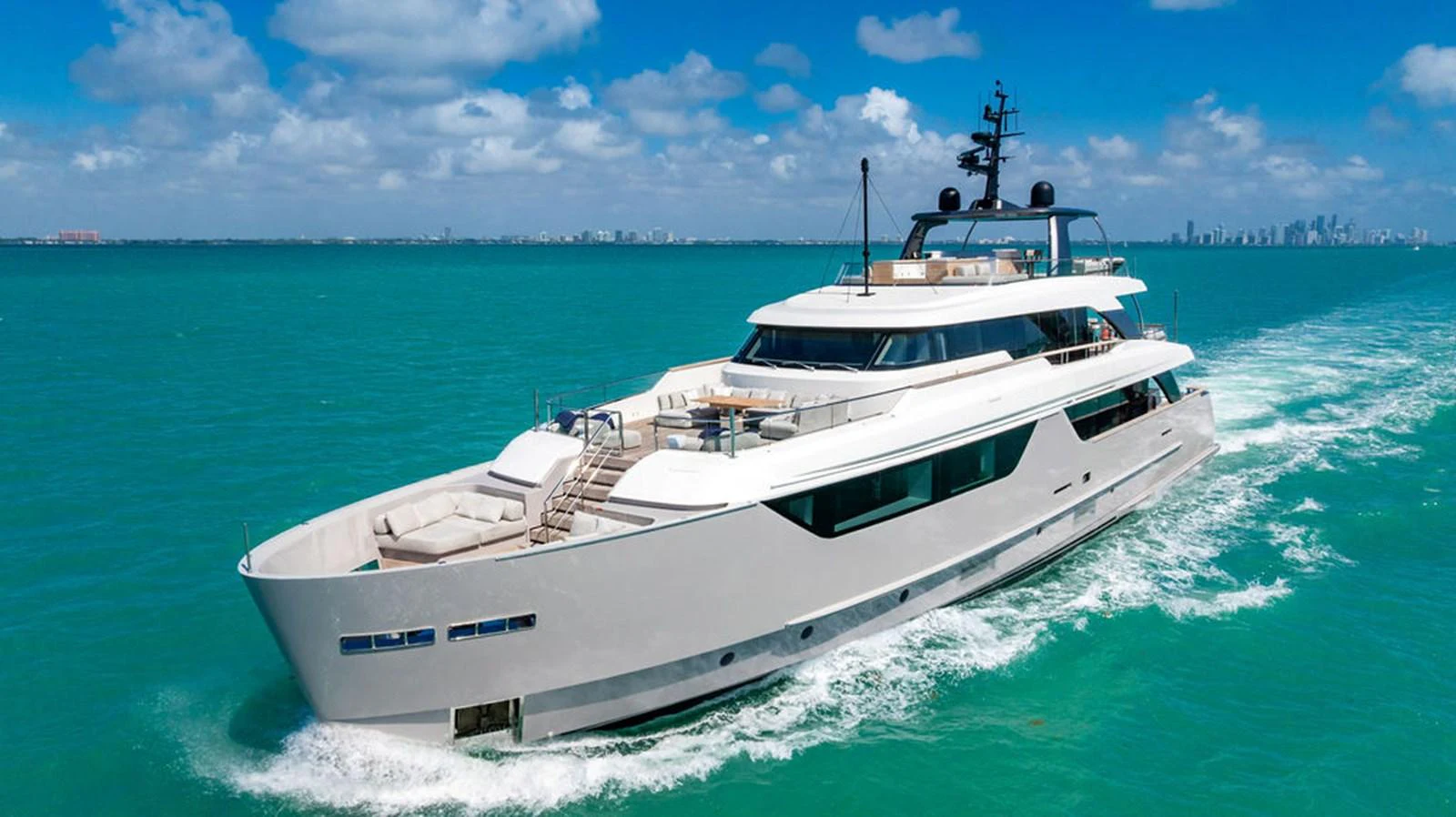 A sleek and modern yacht cruises through turquoise waters under a bright blue sky. aboard SANLORENZO SD118/129 Yacht for Sale