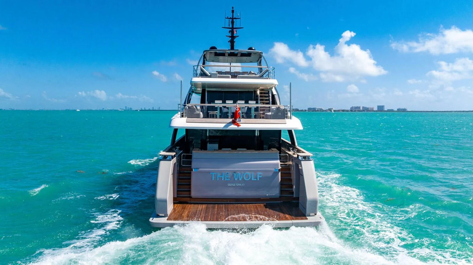 A luxurious yacht sails on turquoise waters under a clear blue sky. aboard SANLORENZO SD118/129 Yacht for Sale