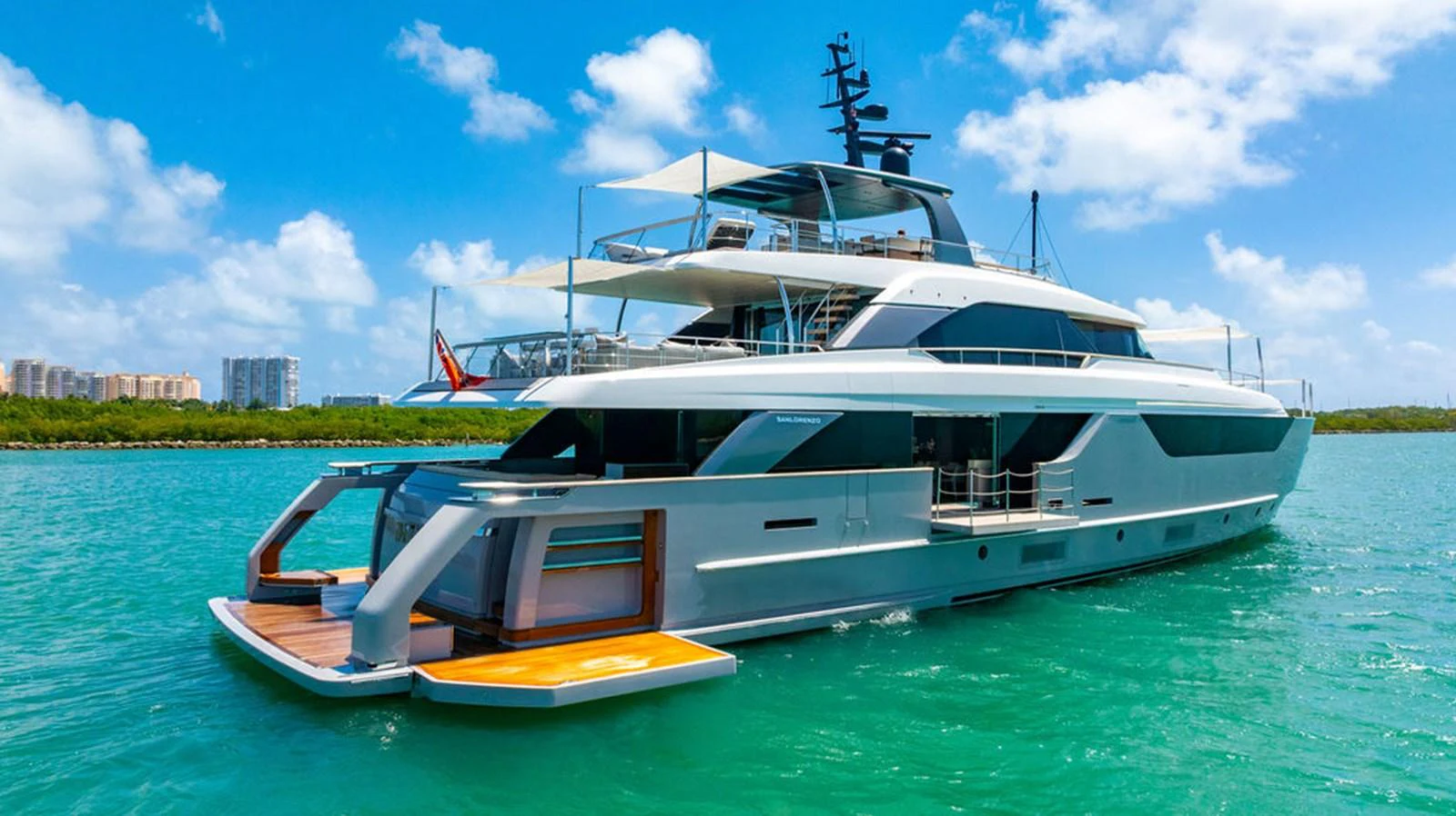 A sleek and modern yacht cruising on clear blue waters under a bright sky. aboard SANLORENZO SD118/129 Yacht for Sale