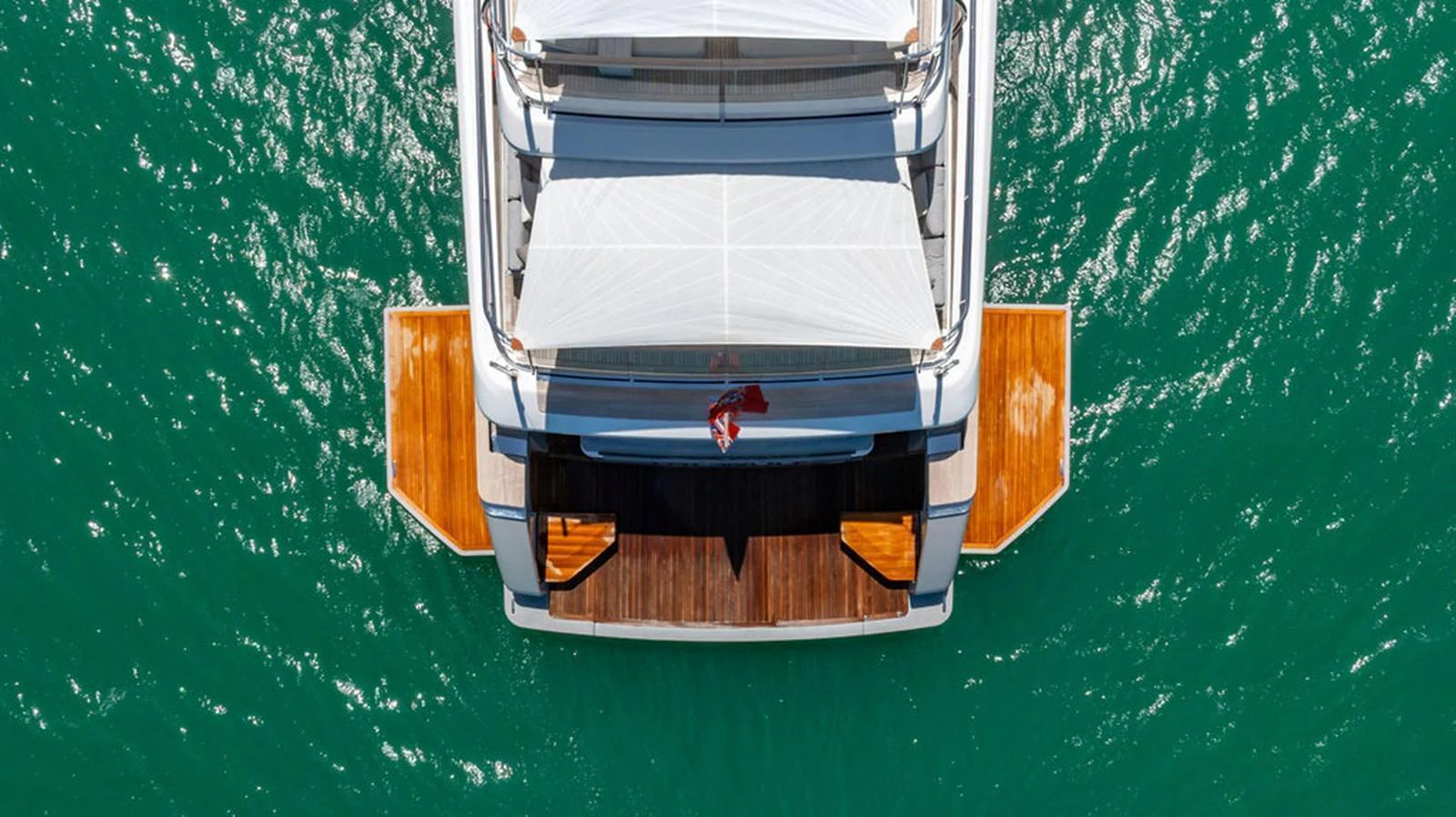 The yacht's aft deck features a spacious swim platform and elegant design, perfect for water activities. aboard SANLORENZO SD118/129 Yacht for Sale