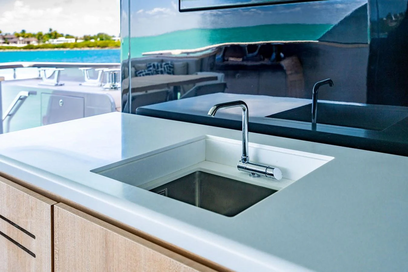A sleek and modern galley sink area with a polished countertop and a view of the sea. aboard SANLORENZO SD118/129 Yacht for Sale