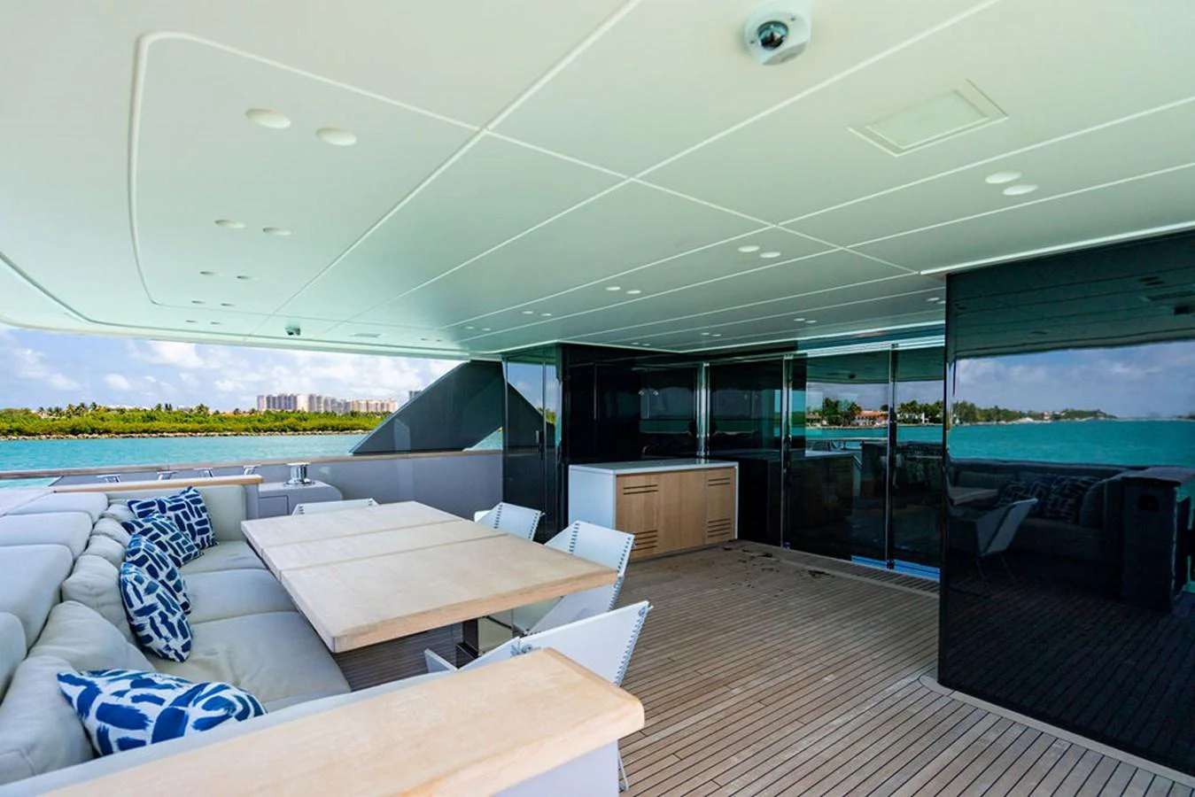 The aft deck features a spacious seating area with a dining table, perfect for alfresco meals with a view of the water. aboard SANLORENZO SD118/129 Yacht for Sale