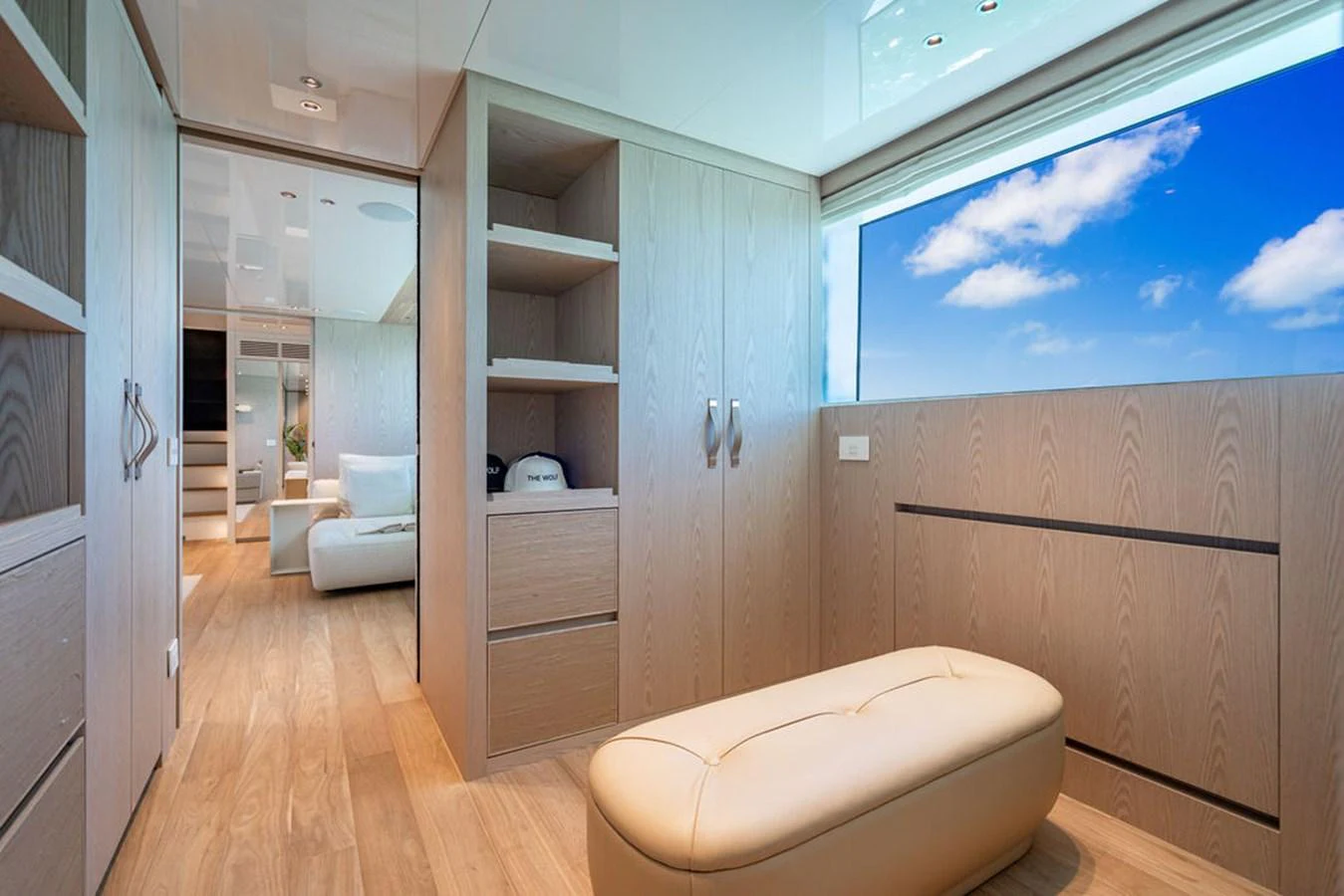 This serene stateroom features light wood finishes and a large window with a view of the sky. aboard SANLORENZO SD118/129 Yacht for Sale
