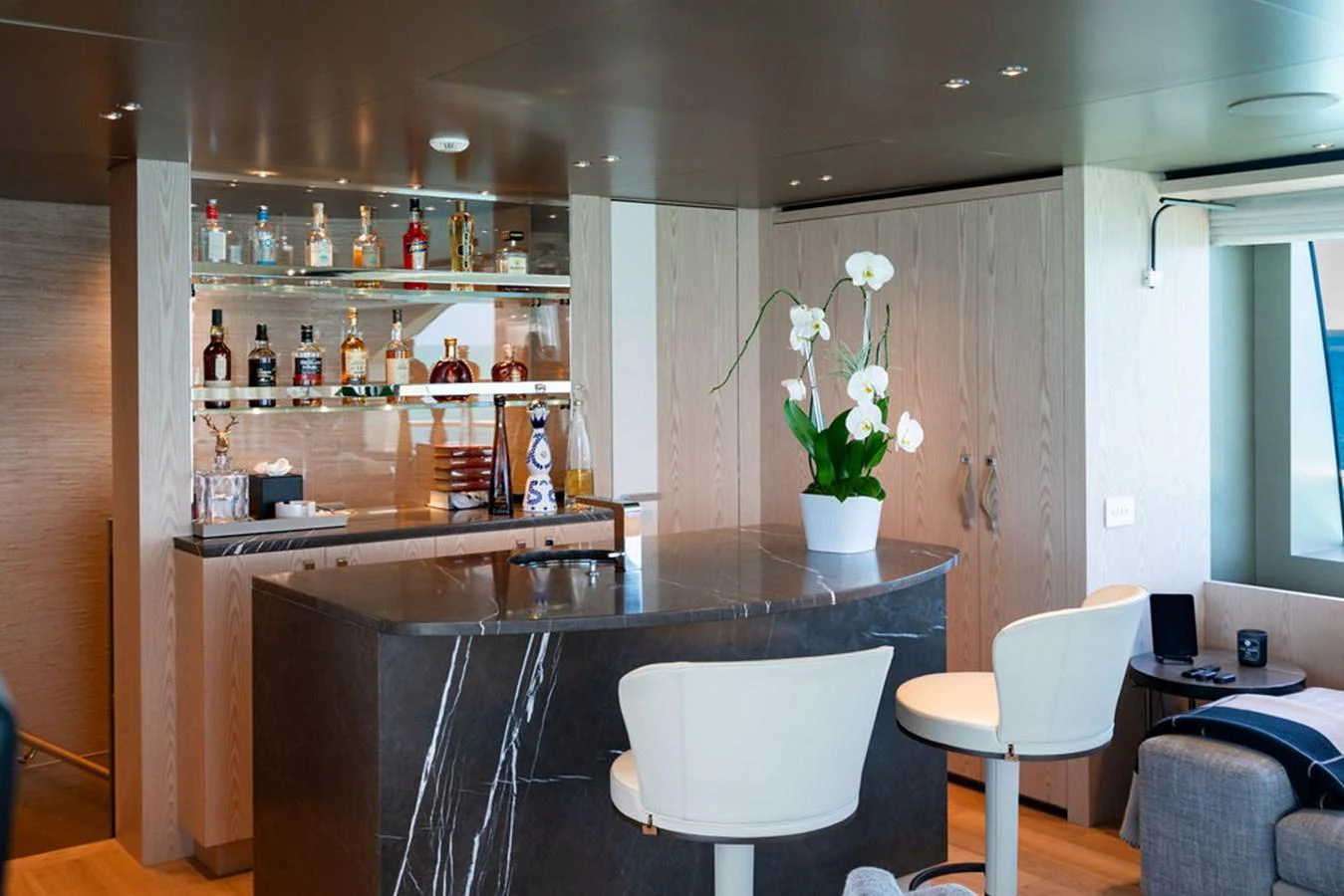 The yacht's interior features a sophisticated bar area with elegant seating and a well-stocked selection of spirits. aboard SANLORENZO SD118/129 Yacht for Sale