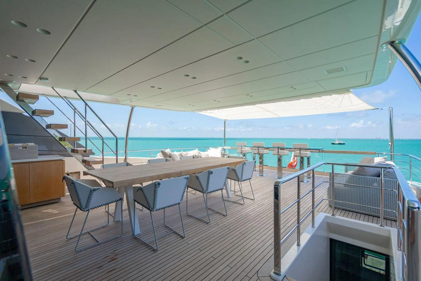 The aft deck features a spacious dining area with stunning ocean views. aboard SANLORENZO SD118/129 Yacht for Sale