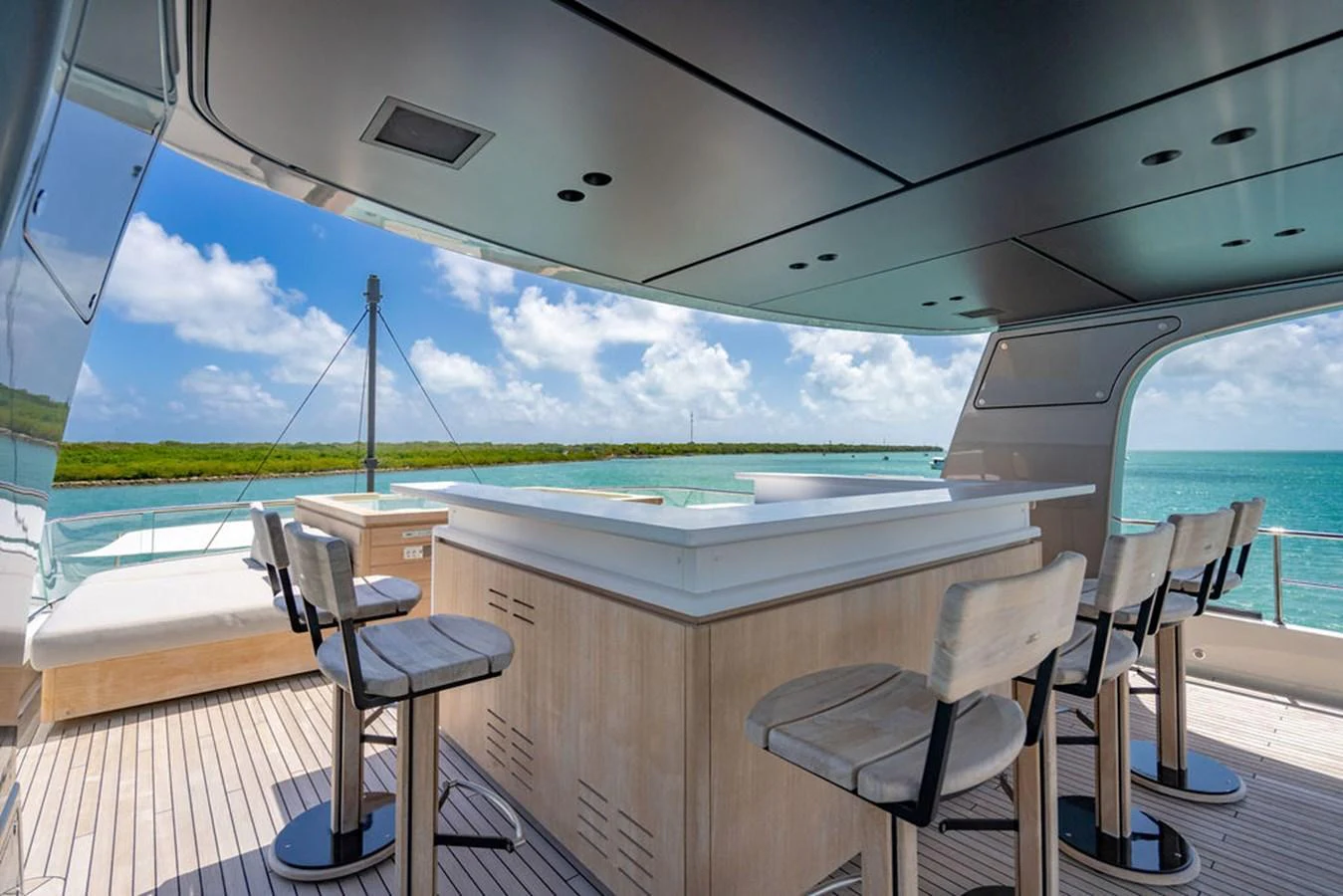 The flybridge features a stylish bar area with seating, offering stunning views of the surrounding waters. aboard SANLORENZO SD118/129 Yacht for Sale