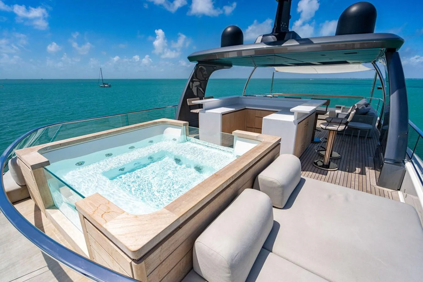 The sundeck features a luxurious hot tub with panoramic ocean views, complemented by plush seating and a sleek bar area. aboard SANLORENZO SD118/129 Yacht for Sale