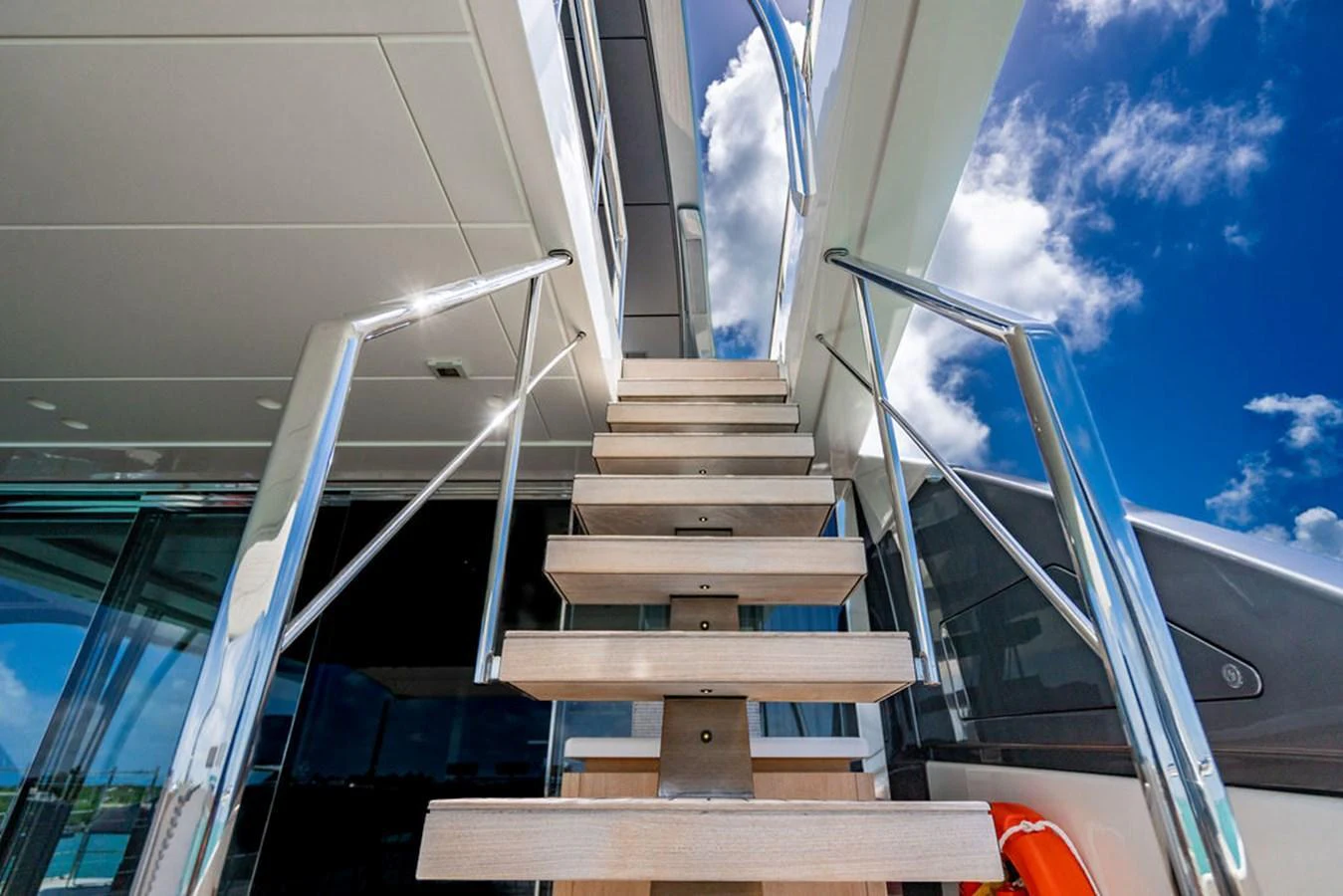 A modern staircase with sleek railings leads to the upper deck of the yacht. aboard SANLORENZO SD118/129 Yacht for Sale