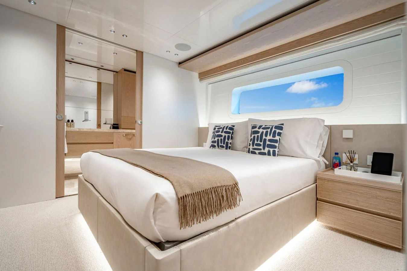 The stateroom features a luxurious bed with modern decor and ample natural light. aboard SANLORENZO SD118/129 Yacht for Sale