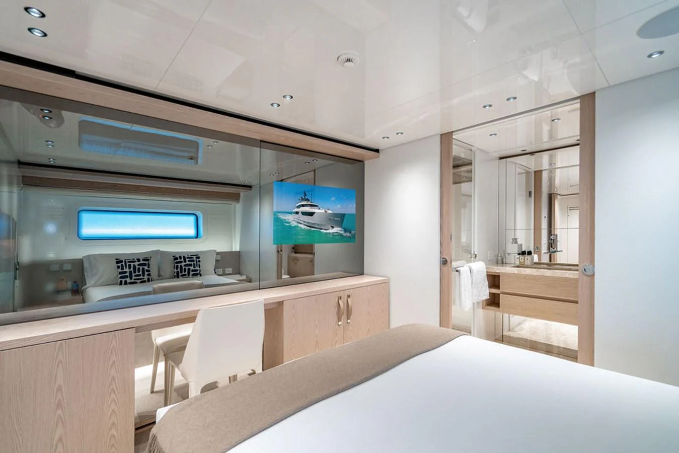 The stateroom features a modern design with a large mirror, a comfortable bed, and an ensuite bathroom. aboard SANLORENZO SD118/129 Yacht for Sale
