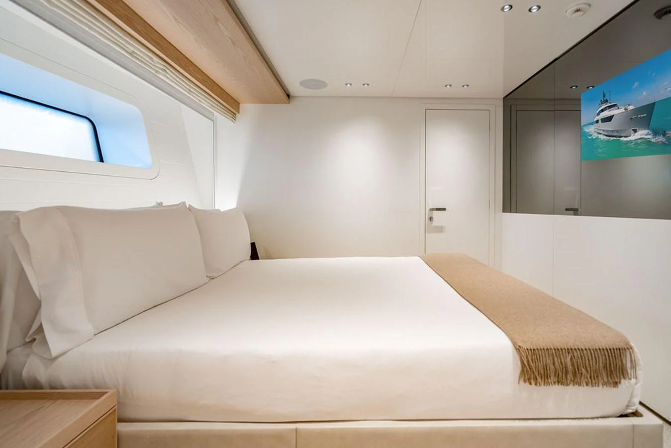 The stateroom features a luxurious bed with crisp white linens and a modern, minimalist design. aboard SANLORENZO SD118/129 Yacht for Sale