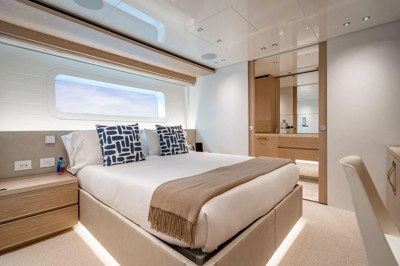 A luxurious stateroom featuring a large bed, modern furnishings, and ample natural light. aboard SANLORENZO SD118/129 Yacht for Sale