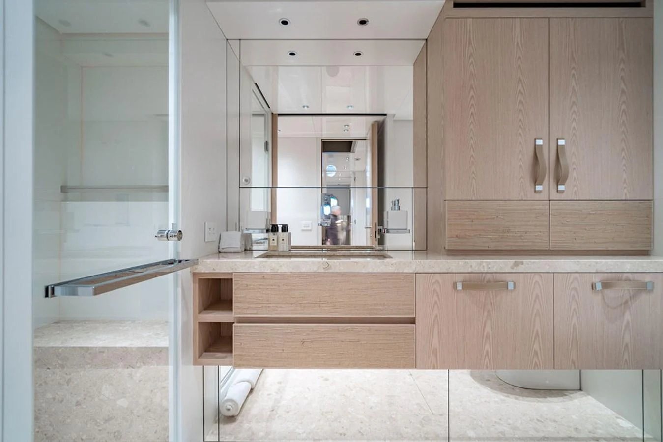 A modern yacht bathroom featuring sleek cabinetry and a large mirror. aboard SANLORENZO SD118/129 Yacht for Sale