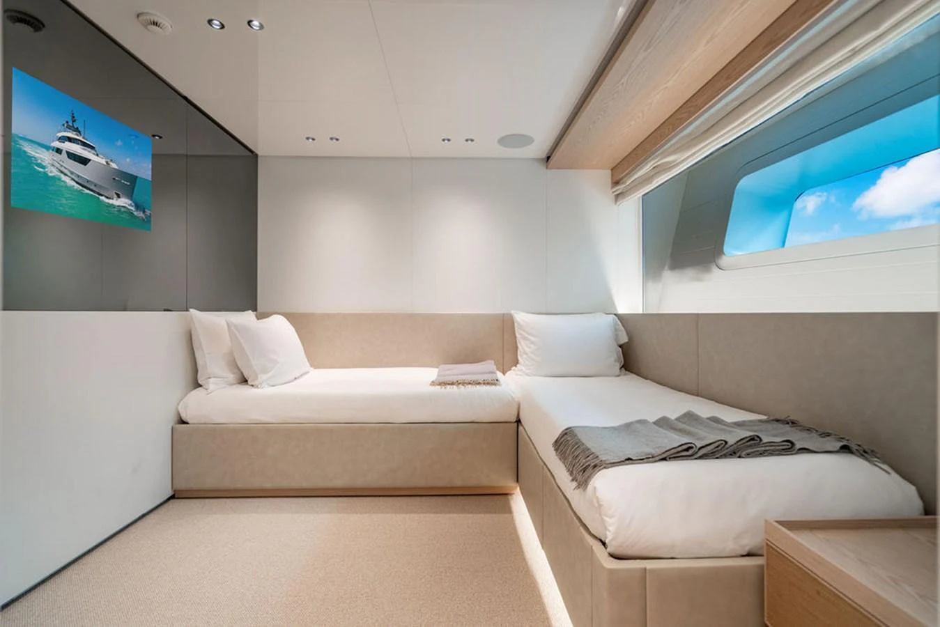The guest cabin features two single beds with a modern, minimalist design and a large window providing natural light. aboard SANLORENZO SD118/129 Yacht for Sale