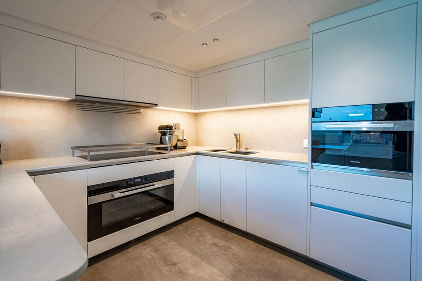 The yacht's galley is modern and well-equipped with sleek appliances and ample counter space. aboard SANLORENZO SD118/129 Yacht for Sale
