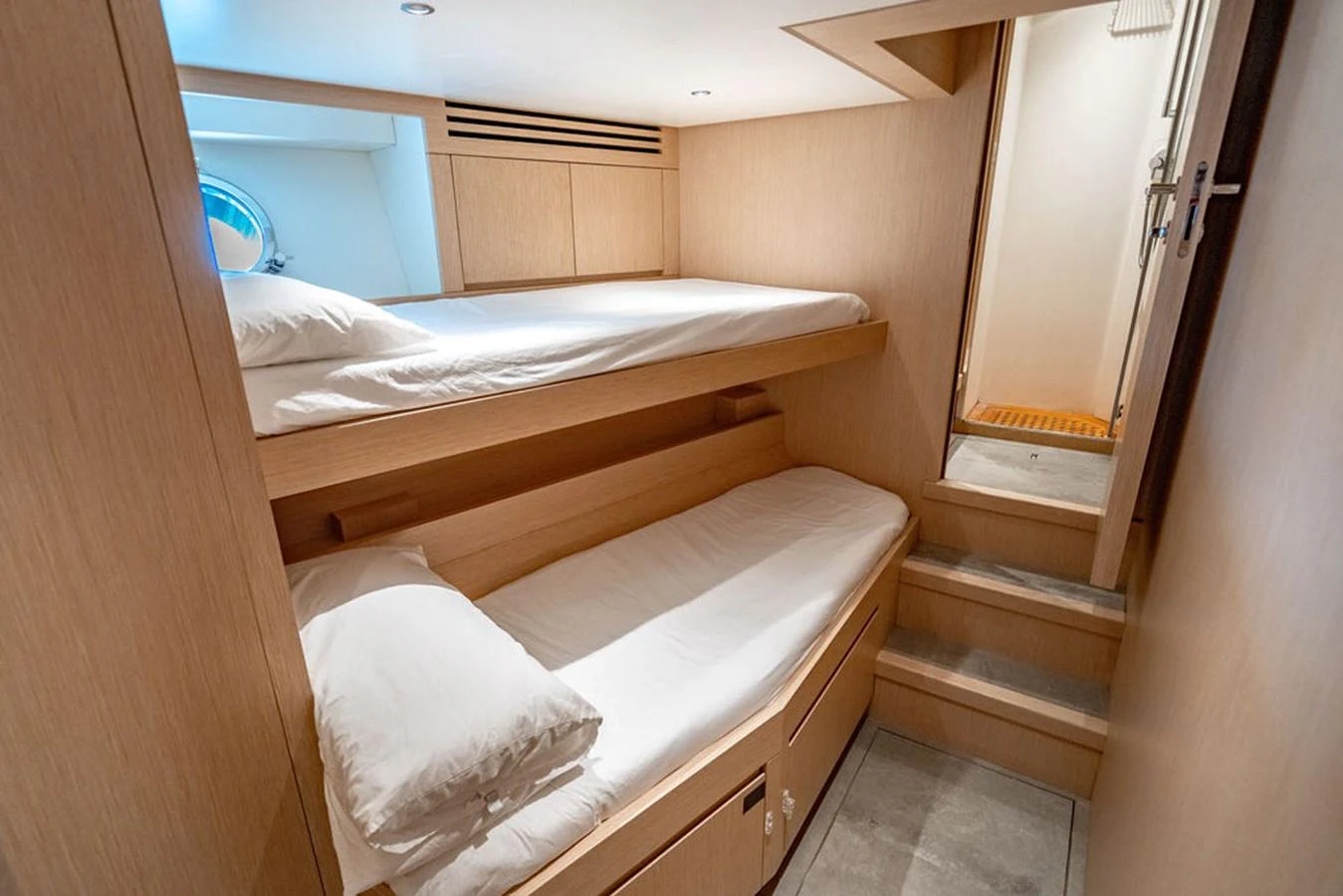 A cozy cabin with bunk beds and natural wood finishes. aboard SANLORENZO SD118/129 Yacht for Sale