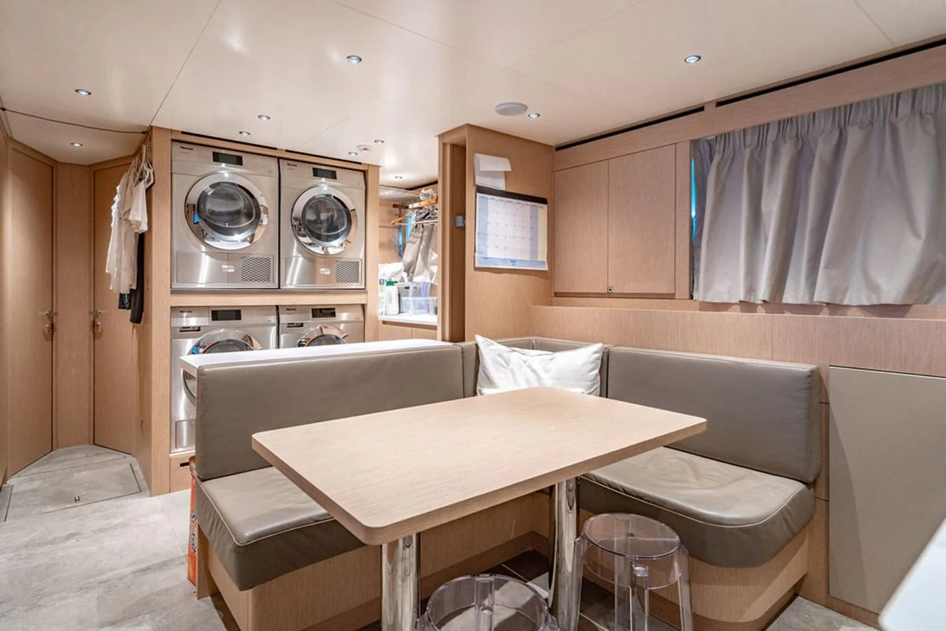 The yacht's laundry room features modern appliances and a cozy seating area. aboard SANLORENZO SD118/129 Yacht for Sale