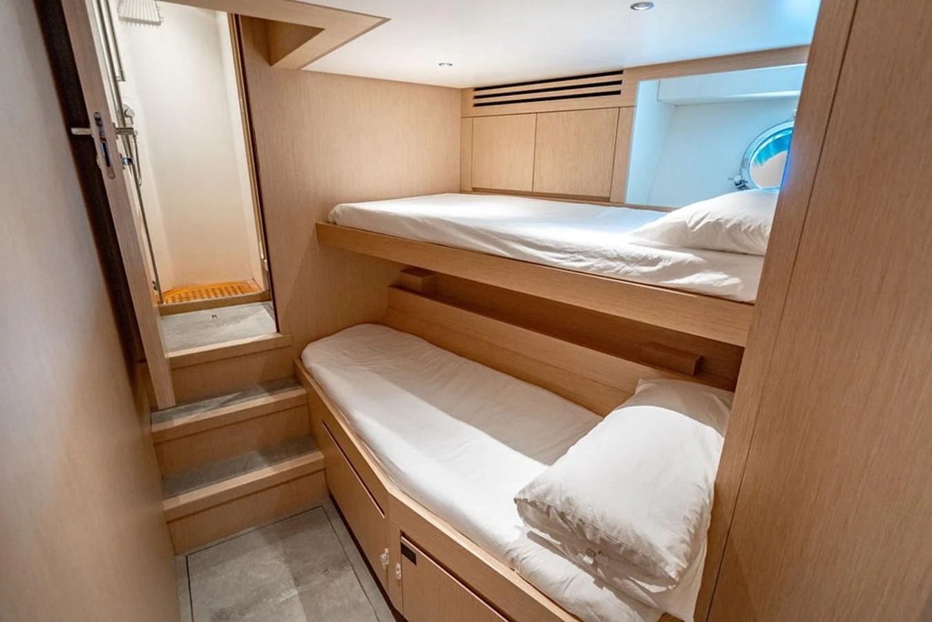 A cozy cabin with bunk beds and modern wooden finishes. aboard SANLORENZO SD118/129 Yacht for Sale