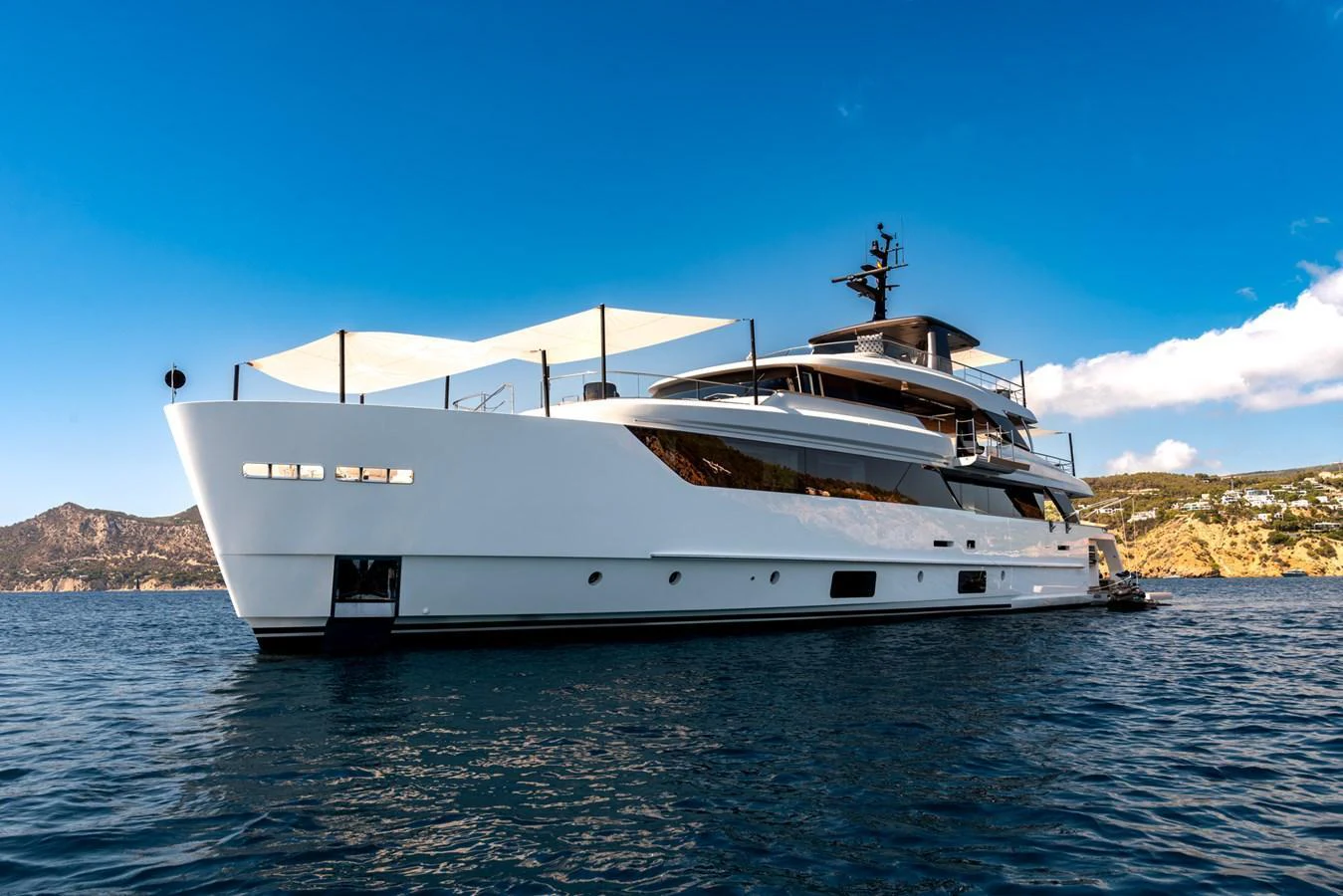 A sleek and modern yacht glides gracefully on the water under a clear blue sky. aboard AV1 Yacht for Sale