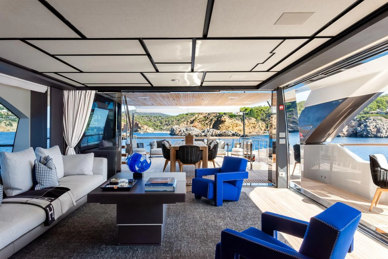 The salon features modern furnishings with expansive views of the surrounding seascape. aboard AV1 Yacht for Sale