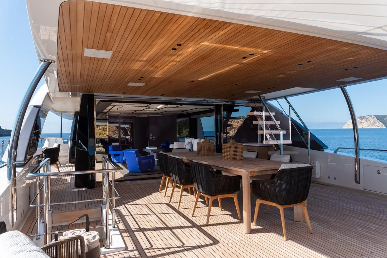 The aft deck features a spacious and stylish outdoor dining area with stunning ocean views. aboard AV1 Yacht for Sale