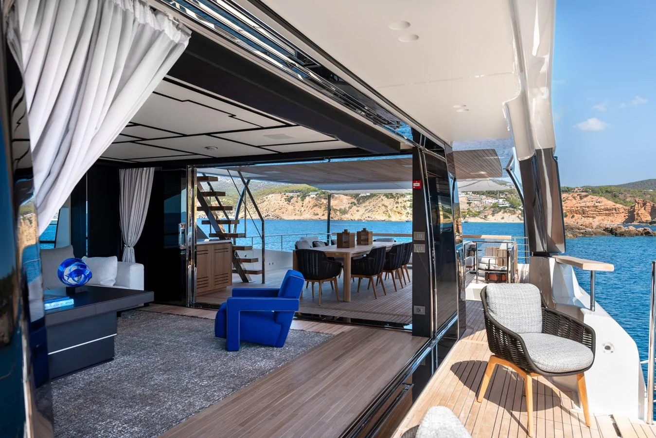 The yacht's salon opens seamlessly to the aft deck, offering a luxurious and spacious living area with stunning sea views. aboard AV1 Yacht for Sale