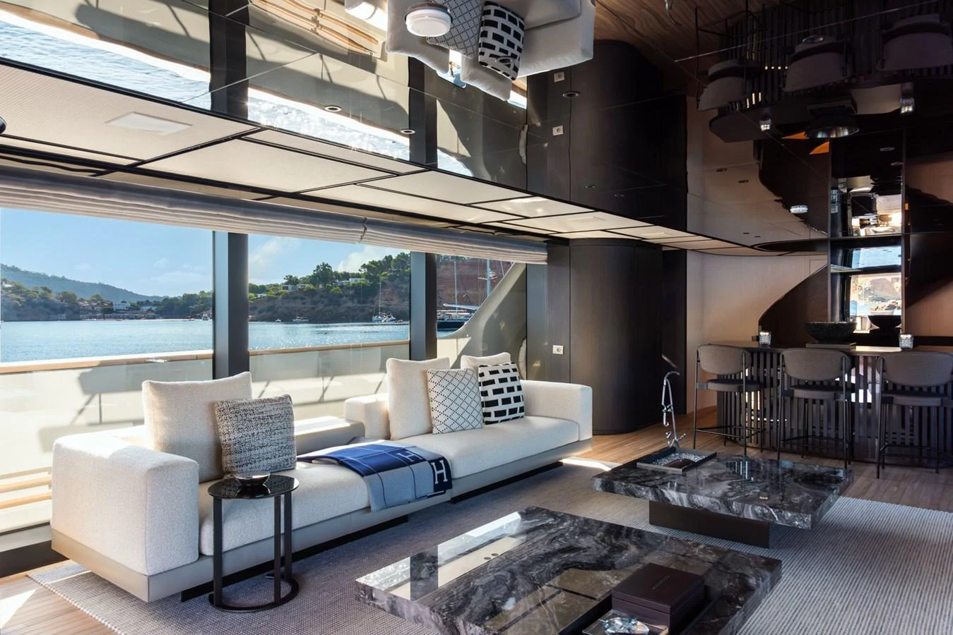 The salon features modern furnishings with panoramic windows offering stunning sea views. aboard AV1 Yacht for Sale