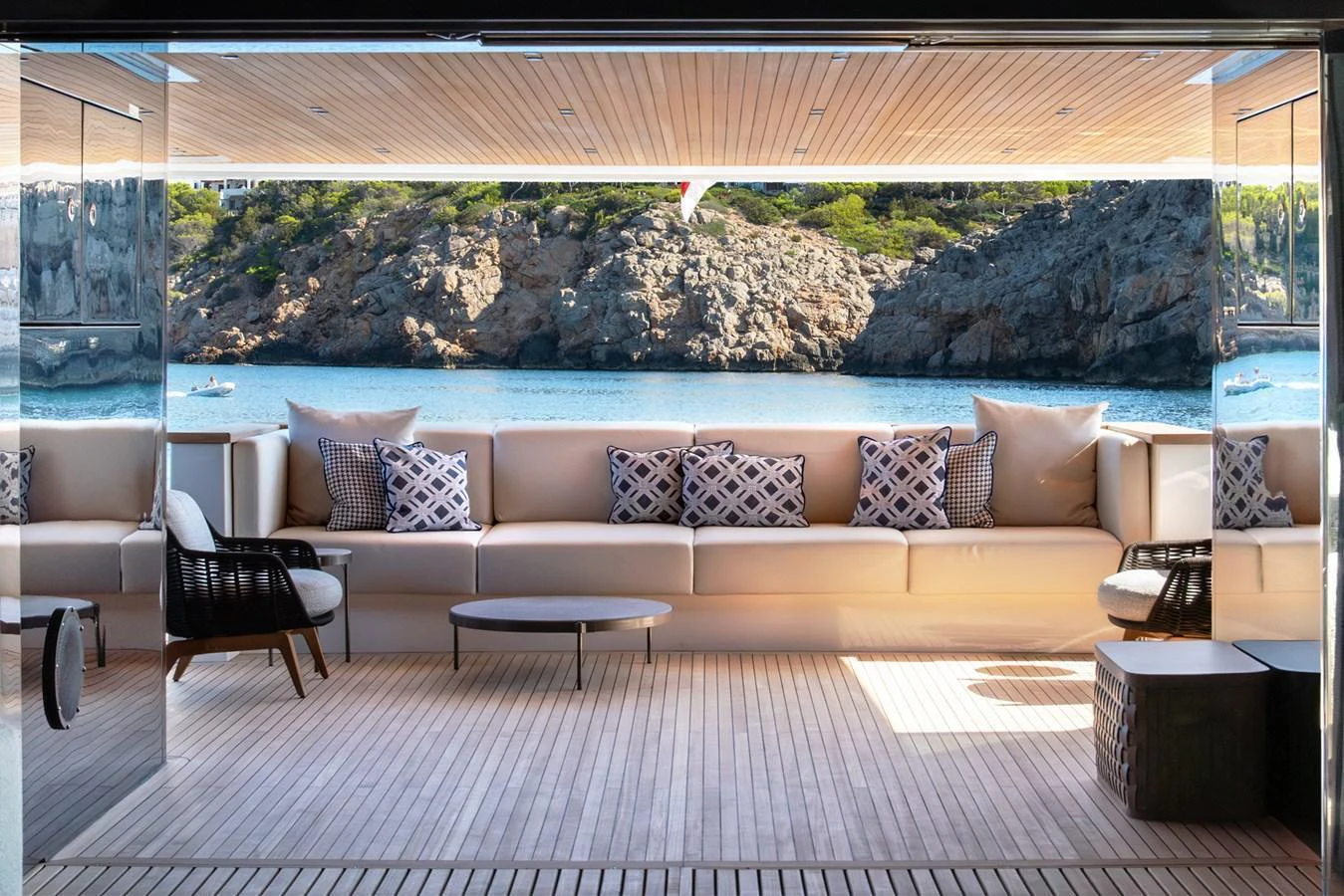 The aft deck features a spacious seating area with a stunning view of the water and surrounding landscape. aboard AV1 Yacht for Sale