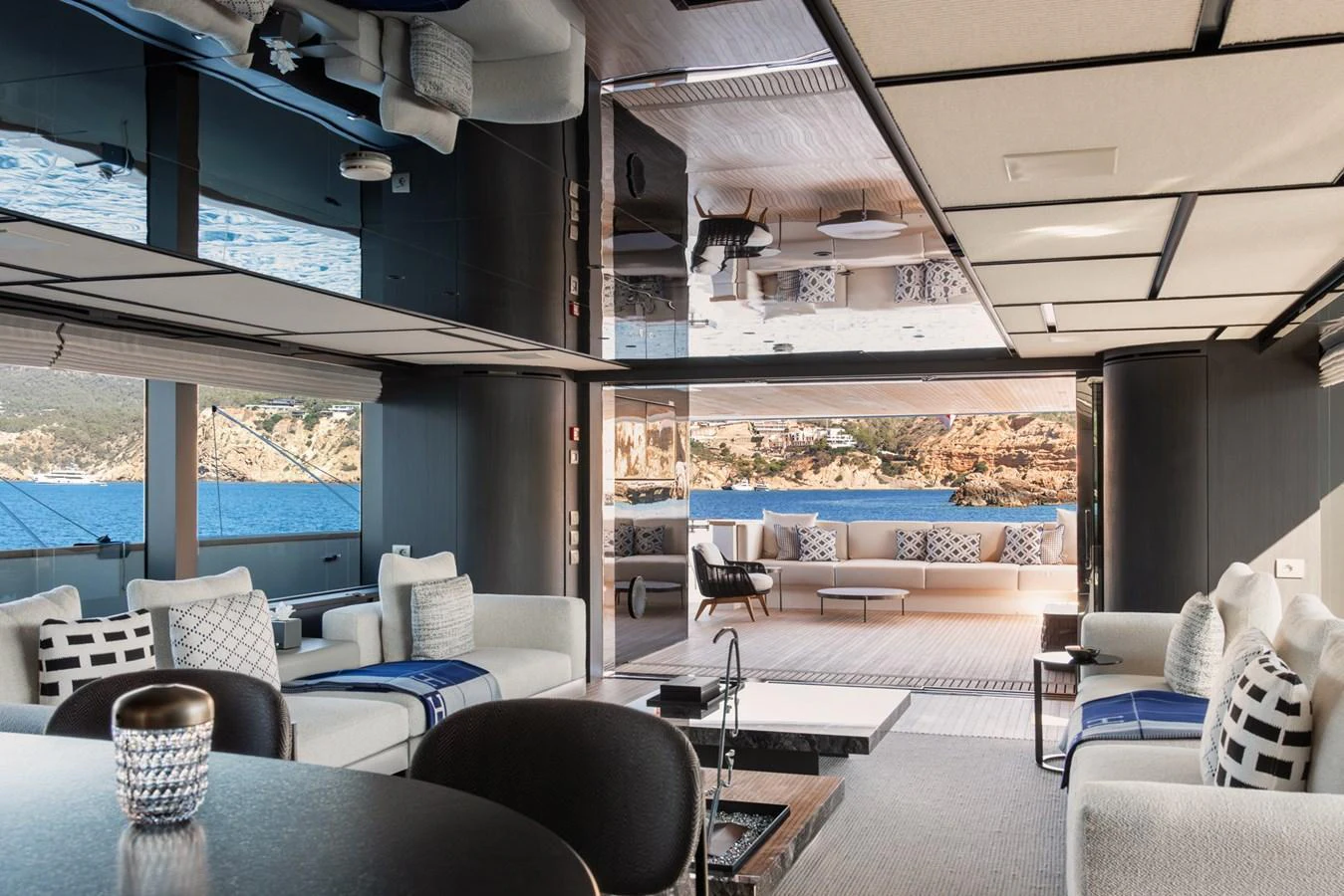 The spacious salon features modern furnishings and opens to a stunning view of the sea. aboard AV1 Yacht for Sale
