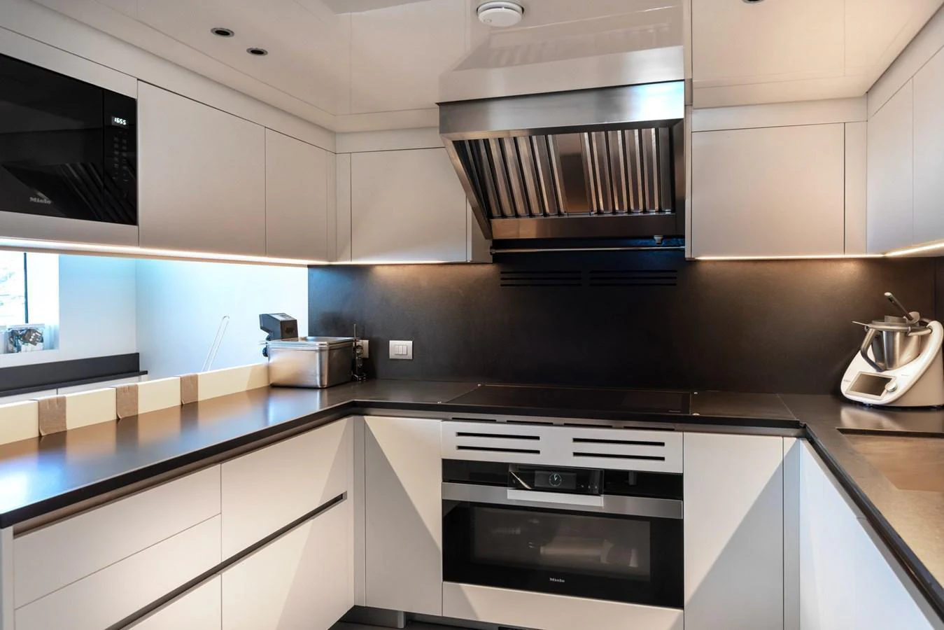 The galley features modern appliances and sleek cabinetry, perfect for gourmet cooking at sea. aboard AV1 Yacht for Sale