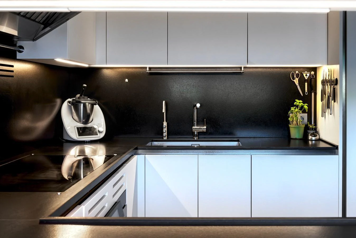 The modern galley features sleek cabinetry, high-end appliances, and a minimalist design. aboard AV1 Yacht for Sale
