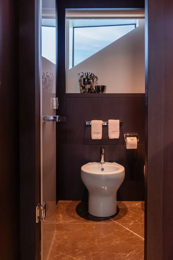 A sleek and modern yacht bathroom with elegant finishes and a large window for natural light. aboard AV1 Yacht for Sale