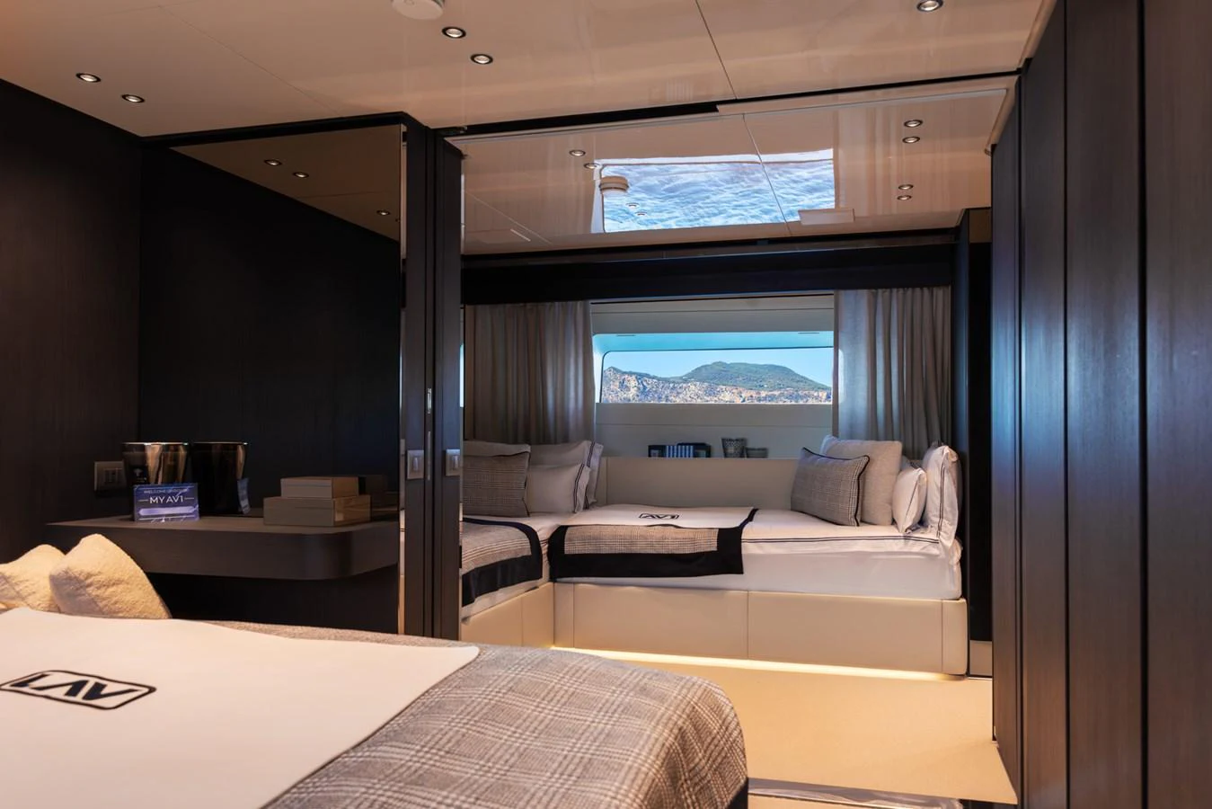 A luxurious stateroom with a large window offering a scenic view. aboard AV1 Yacht for Sale