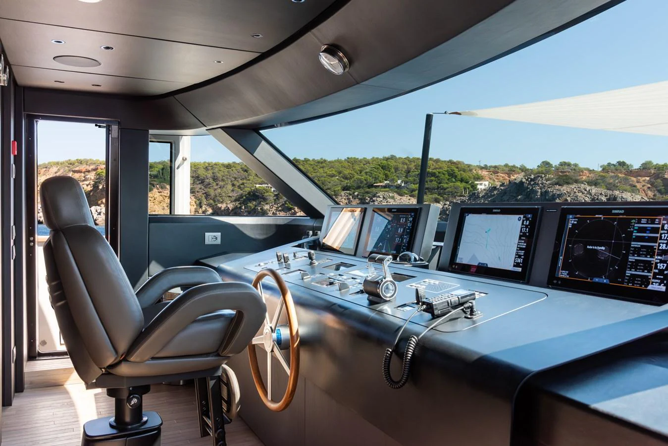 The helm features state-of-the-art navigation equipment and a comfortable captain's chair with panoramic views. aboard AV1 Yacht for Sale