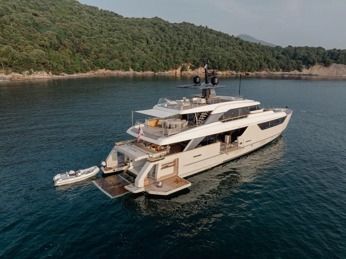 A luxurious yacht anchored in a serene bay, showcasing its elegant design and spacious decks. aboard LET IT BE Yacht for Sale