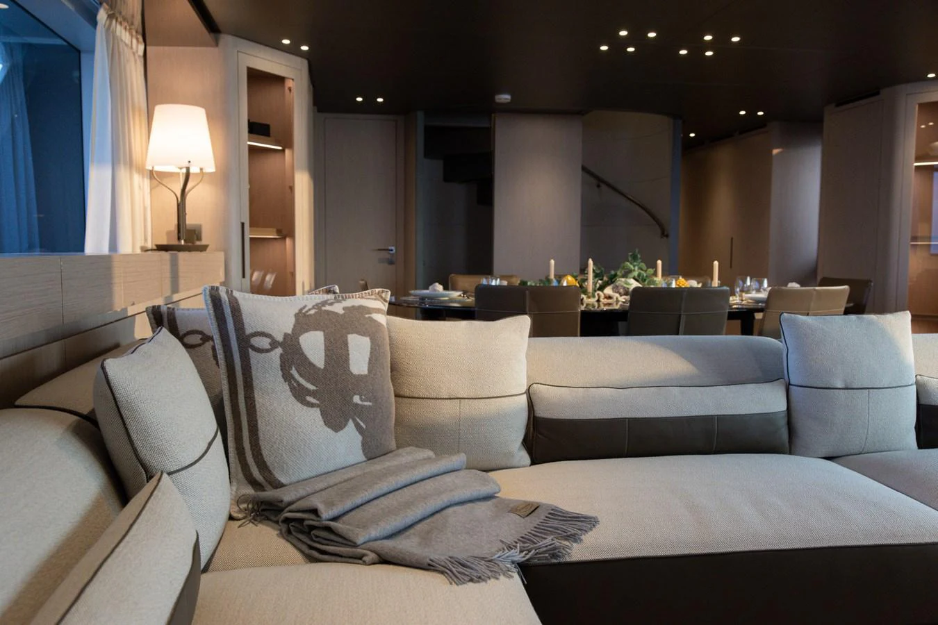 The salon features a cozy seating area with elegant decor and ambient lighting. aboard LET IT BE Yacht for Sale