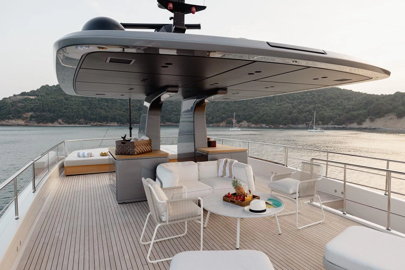 The sundeck offers a luxurious outdoor seating area with modern furnishings and a stunning view of the water. aboard LET IT BE Yacht for Sale