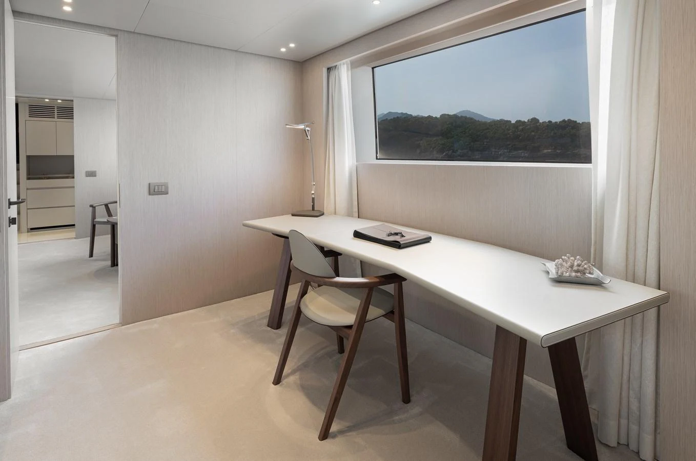 A serene office space with a large window offering a view of the sea. aboard LET IT BE Yacht for Sale