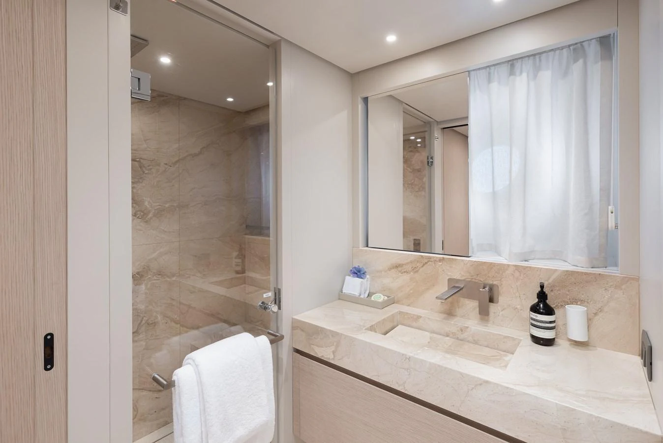 The yacht's bathroom features a sleek design with a spacious shower and elegant fixtures. aboard LET IT BE Yacht for Sale