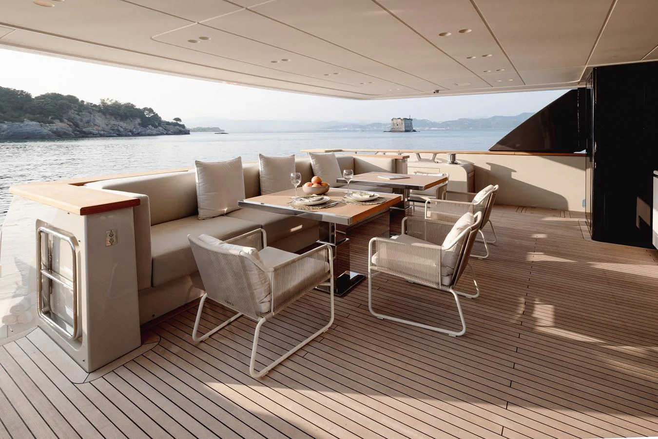 The aft deck features a stylish outdoor dining area with comfortable seating and scenic views. aboard LET IT BE Yacht for Sale