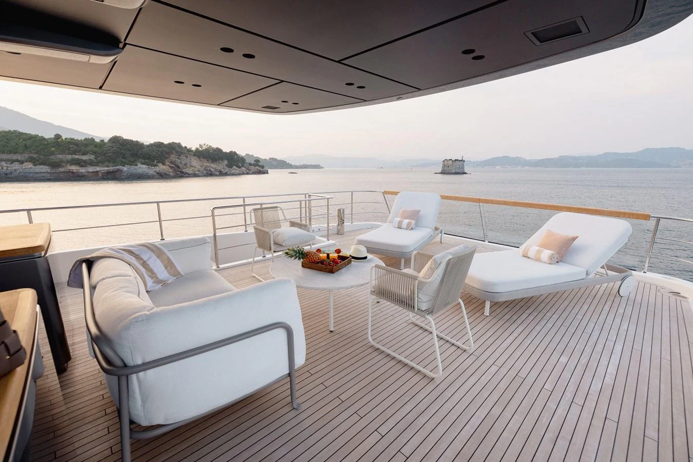 The aft deck offers a serene lounging area with comfortable seating and stunning ocean views. aboard LET IT BE Yacht for Sale