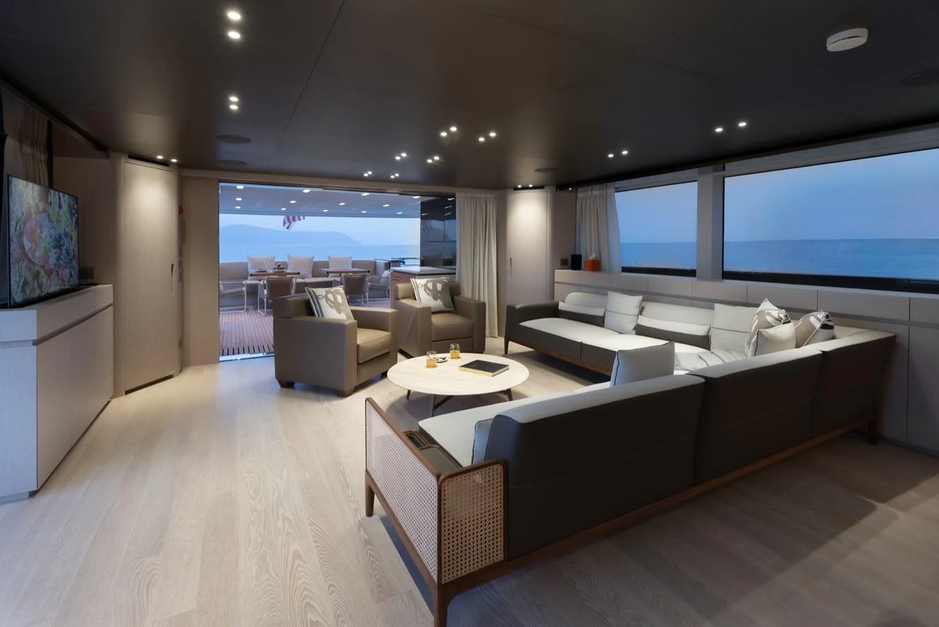 The spacious salon offers a luxurious and comfortable seating area with a view of the ocean. aboard LET IT BE Yacht for Sale