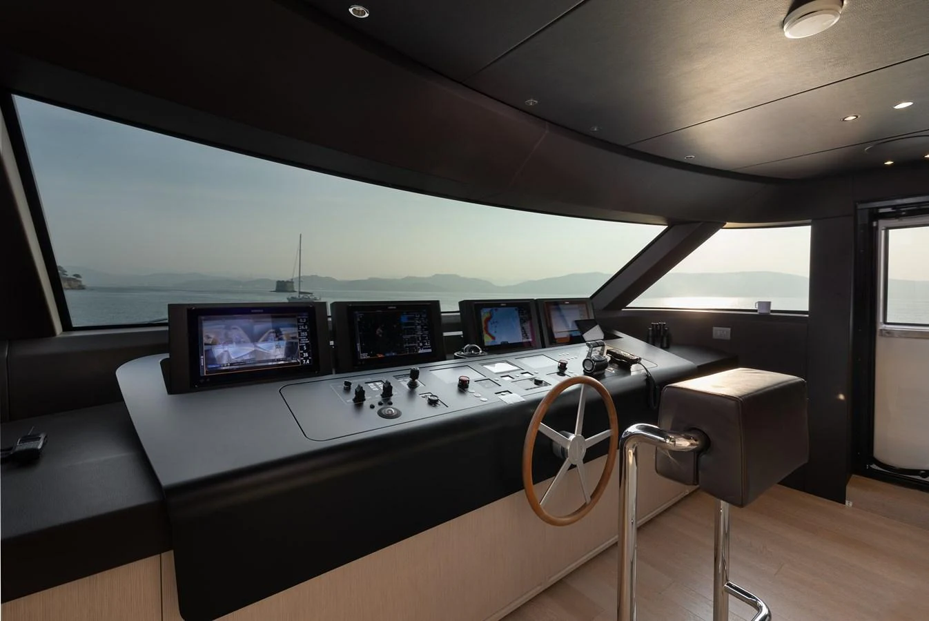 The helm station offers a sleek and modern command center with panoramic views. aboard LET IT BE Yacht for Sale