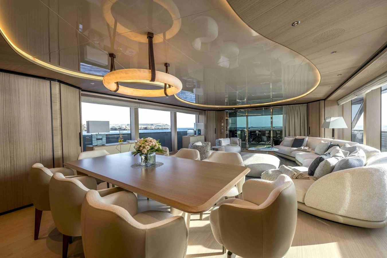 The spacious salon features elegant seating and a stylish dining area with panoramic views. aboard UNIQUE S Yacht for Sale