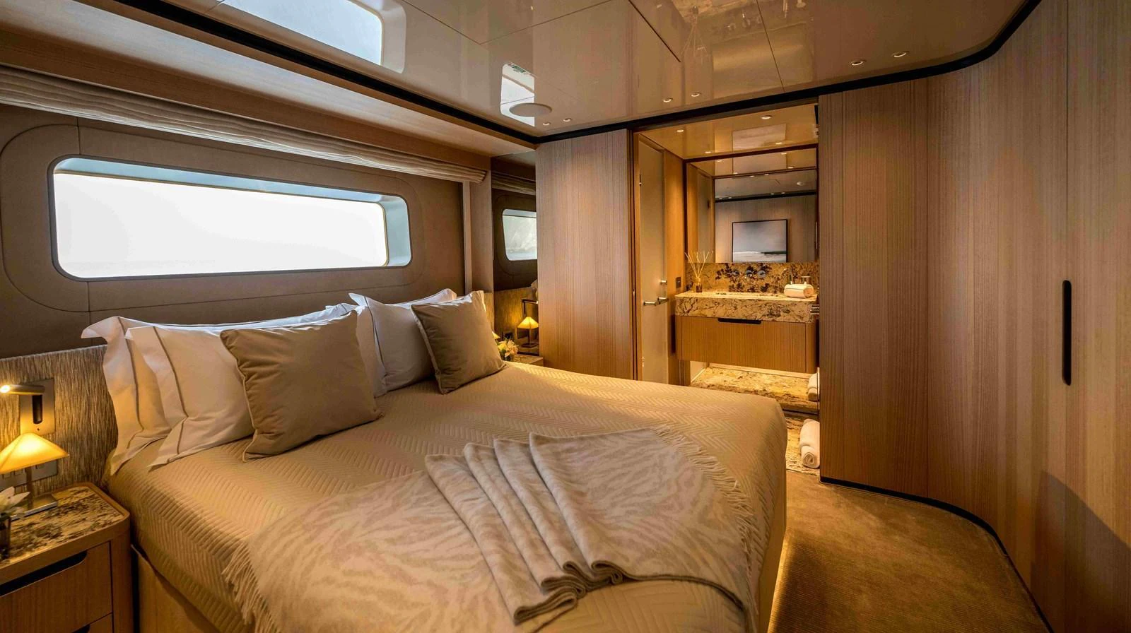The master stateroom features a luxurious bed and elegant decor with ample natural light. aboard UNIQUE S Yacht for Sale