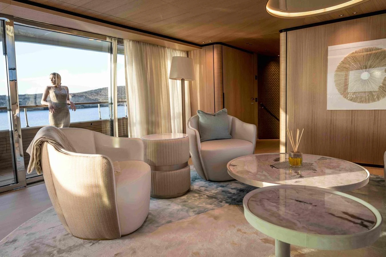 The salon features elegant seating with a serene view through large windows. aboard UNIQUE S Yacht for Sale