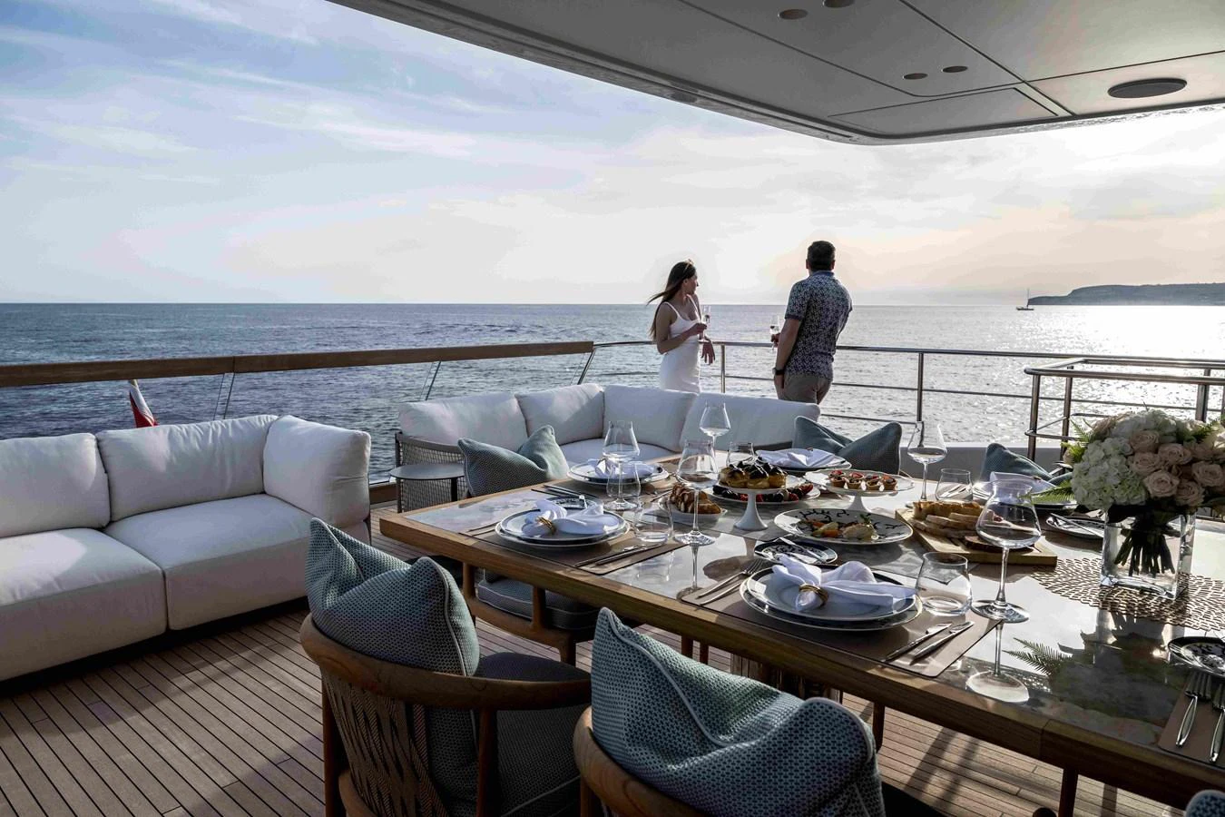 The aft deck features an elegant dining area with a stunning ocean view. aboard UNIQUE S Yacht for Sale